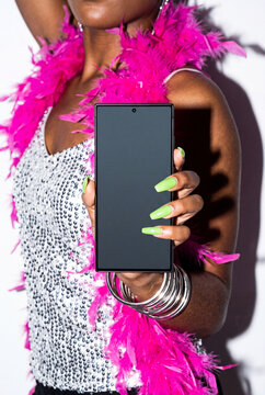 Partygoer in Feather Boa Showing Phone