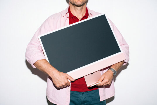Man Carrying Pink Desktop Computer