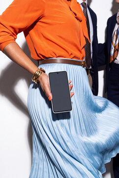 Businesswoman in Pleated Skirt With Phone