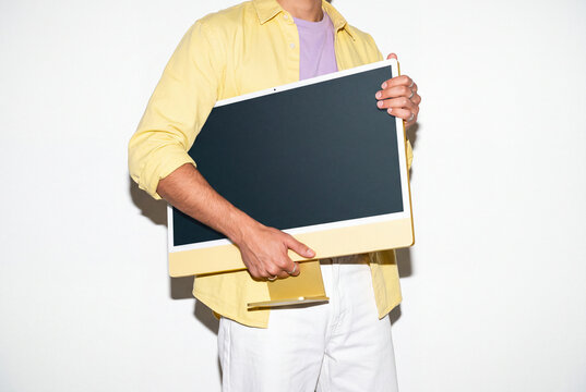 Young Man Carrying Yellow Computer