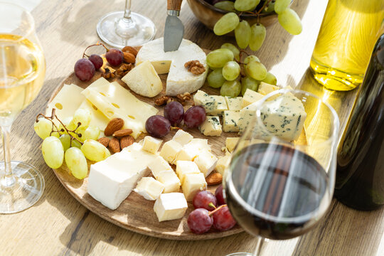 Appetizer Board Cheese Selection Grapes Nuts Wine Glasses Refreshments Delicious Refreshing Snack