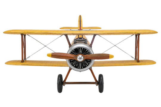 Front view of a vintage yellow biplane model isolated on a clean white studio background