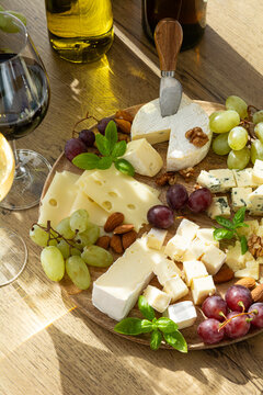 Gourmet cheese board with grapes almonds and wine for elegant appetizer or celebration