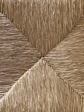 Natural twisted straw or seagrass weave texture with geometric interlocking pattern, organic fiber closeup