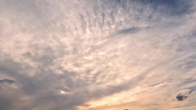 Flowing dramatic colorful clouds in the blue skies. 4K video (Ultra High Definition) of cloudscape. Sky and clouds Timelapse. Stunning summer sunrise.