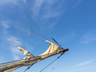 Low Angle View of Tall Ship Bowsprit and Rigging Against Blue Sky © Bjorn B