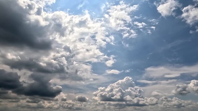 Flowing dramatic clouds in the blue skies. 4K video (Ultra High Definition) of rainy cloudscape. Sky and clouds Timelapse.