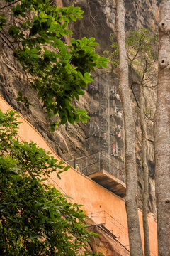 Dambulla, Sri Lanka - 21 December 2025: Ascending the Ancient Sigiriya Rock Fortress with Spiral Staircase in Sri Lanka