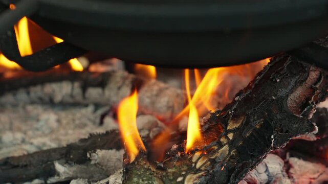 The cauldron is heated by burning coals, close-up shot