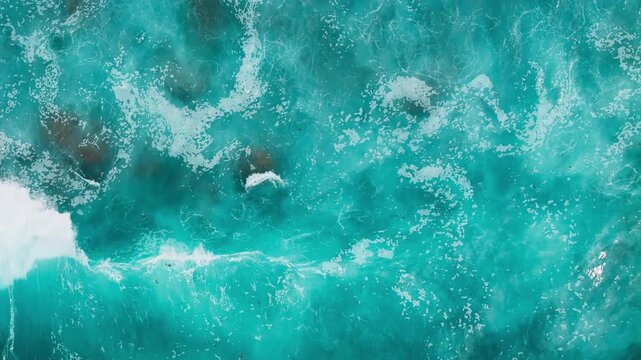 Turquoise Atlantic ocean surface with scattered white foam, top down view. Natural marine background with water texture,