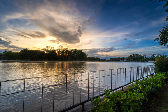 road landscape lake views and the reservoir the forest summer with evening blue dramatic sunset sky nature background.