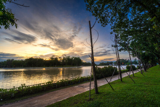 road landscape lake views and the reservoir the forest summer with evening blue dramatic sunset sky nature background.