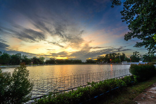 road landscape lake views and the reservoir the forest summer with evening blue dramatic sunset sky nature background.