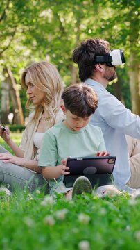 Man in virtual reality glasses enjoys game near wife and son
