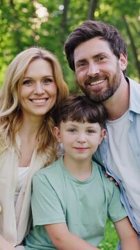 Smiling family shares warm group hug in peaceful urban park