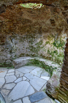 Underground chamber with curved marble bench and oculus in the Catacomb of Saint John the Baptist, Thessaloniki, Greece