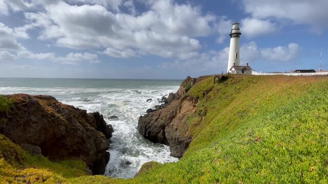 Historic Pigeon Point Lighthouse on Coastal Bluffs Overlooking Crashing Pacific Ocean Waves in California