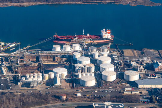 Aerial view of an oil tanker docked at the Kinder Morgan liquid bulk terminal, surrounded by rows of storage tanks in the Fresh Kills reach btw New Jesrsey and Staten Island