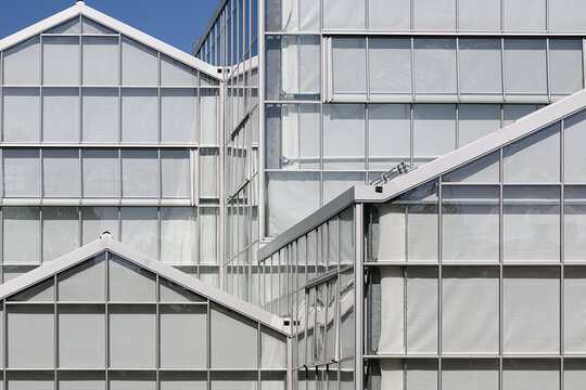 Modern glass greenhouse roofs create geometric architectural pattern.