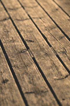 Weathered gray wooden dock planks forming rustic abstract texture.