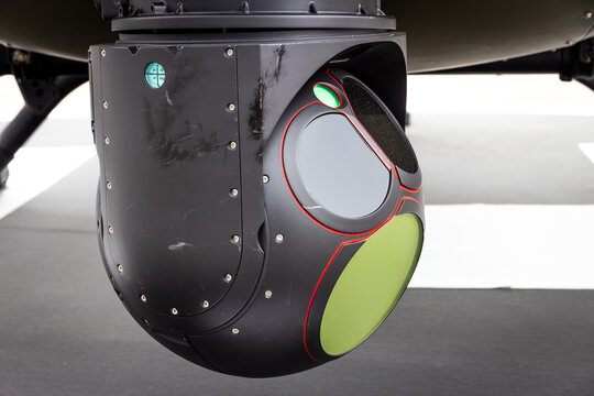 Electro-optical and infrared EO/IR sensor turret with cameras and sensors mounted on a helicopter for aerial surveillance, monitoring and reconnaissance.