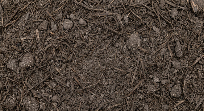 Digestate mineral-fiber residue shown as a heterogeneous full-frame mixture of interwoven fibers, fine mineral particles, and compacted organic material