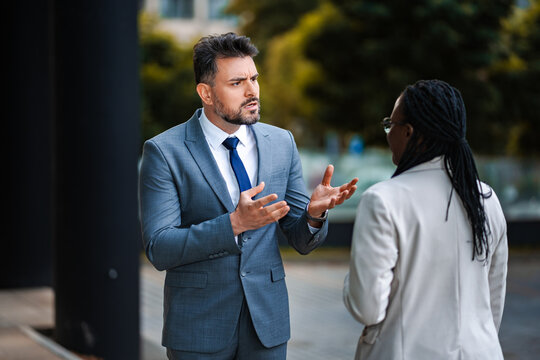 Business people having an outdoor argument and disagreement