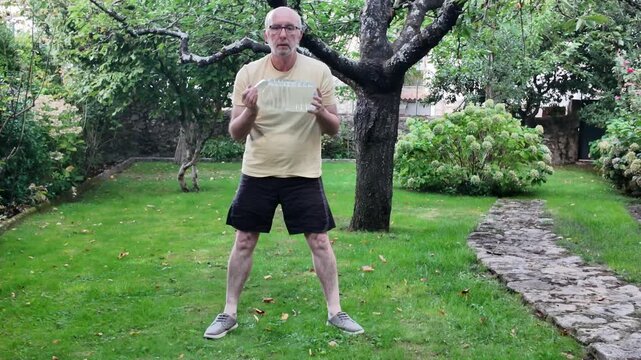 Person performing a squat exercise outdoors