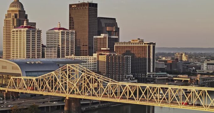 Louisville Kentucky Aerial v62 zoomed flyover Ohio river capturing memorial bridge, riverside freeway traffic and downtown urban cityscape at sunrise - Shot with Mavic 3 Pro Cine - Sept 26th 2023