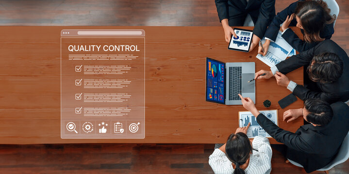 Group of professionals engaged in quality control and data analysis utilizing laptops and digital tools in an office setting, demonstrating collaboration and strategic planning. Nascent