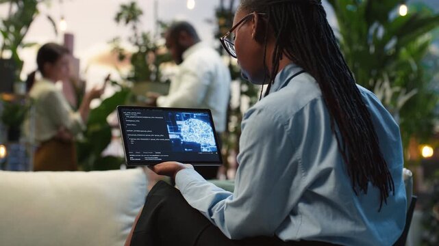 Close-up shows a businesswoman reading AI information on a tablet in a rooftop lounge; she examines a machine learning interface as coworkers continue a project discussion in the rooftop workspace.