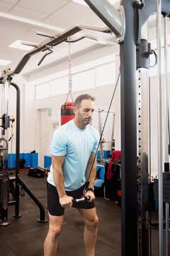 Man performing cable triceps pushdown