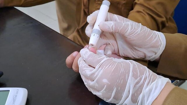 Video footage of employee health screening at an office, showing blood pressure check, blood glucose testing, and weight measurement. Corporate wellness and medical check-up stock video.