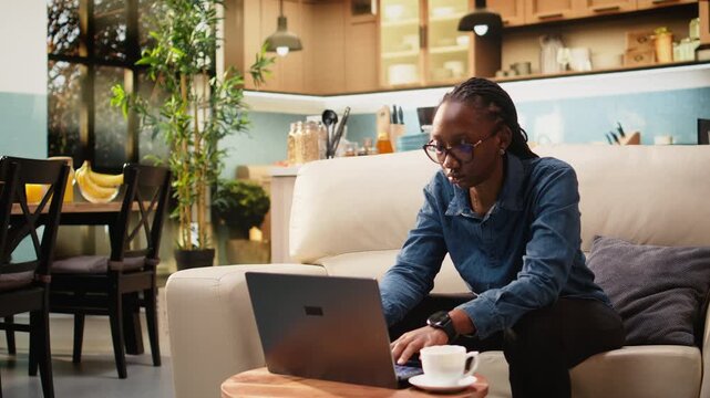 Stressed woman checks wristwatch for time management, anxious about teleworking schedule while a young digital nomad maintains punctuality at home.