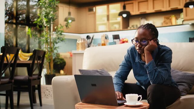Hopeless overworked woman is demotivated by burnout and low energy during monotonous workday at home. Dejected freelancer feels bored with dull occupation and discontent while telecommuting on laptop.