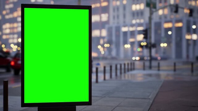 Outdoor advertising mockup: blank green screen board on an urban avenue in soft early morning light, overcast sky. Fast-moving traffic timelapse with cinematic depth of field. Easy chroma key