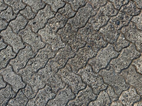 Grey interlocking concrete paving block texture, pavement surface pattern for architecture and outdoor flooring design use