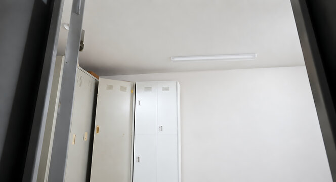 Empty School Locker Room Interior with Open Metal Lockers and Clean White Wall