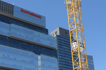 Obraz premium construction crane (Ontario Line site at Corktown) and east facing elevation of Globe and Mail Centre with Scotiabank sign at 351 King St E, Toronto