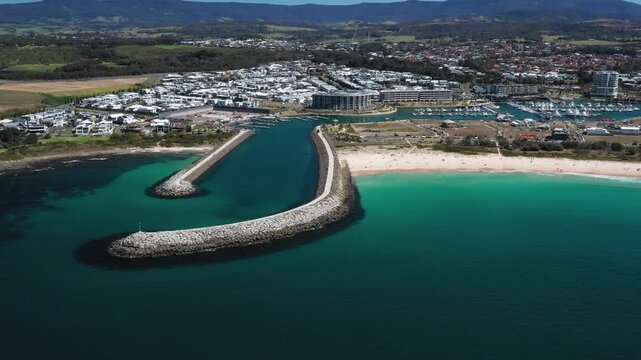 Idyllic view of the Shell Cove breakwater and turquoise blue entrance leading to the scenic Shellharbour Marina, situated on the Illawarra South Coast of New South Wales, Australia. 