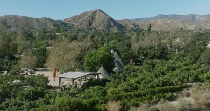 Aerial View of Wooded Neighborhood Below Hills