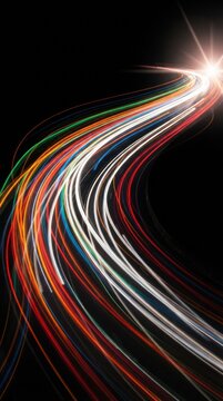 Colorful light trails on a winding road at night