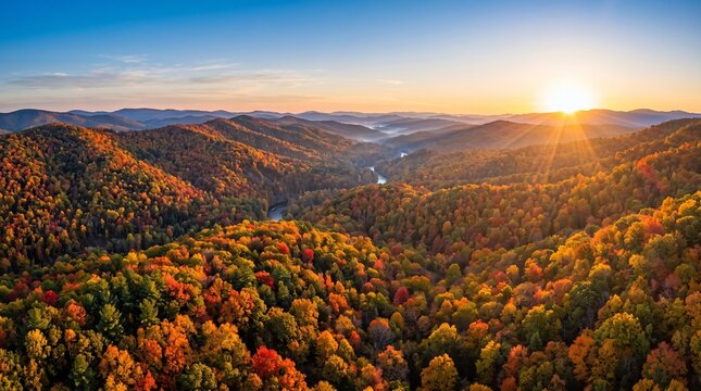 Vibrant autumn landscape showcasing rolling hills covered in colorful trees under a golden morning sunrise with sun rays bursting everywhere