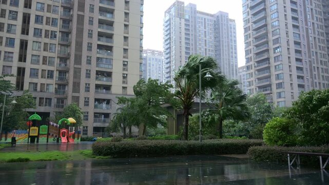 Residential complex garden under strong wind and heavy rain during typhoon video with sound