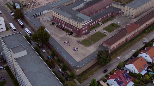 Berlin Hohenschoenhausen Memorial, a former Stasi prison, representing political persecution and communist dictatorship. Best aerial view drone panorama tilt down