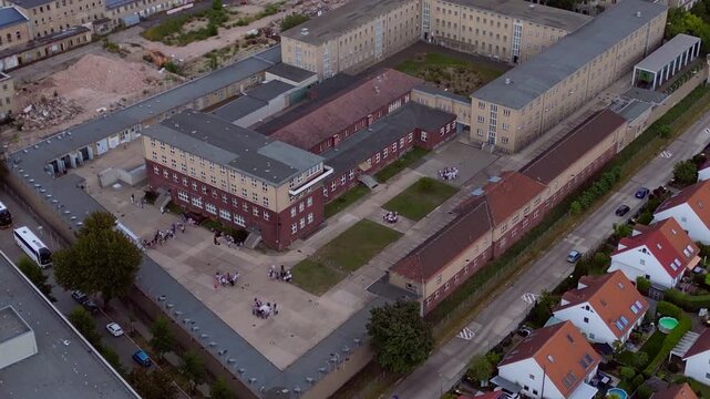 Berlin Hohenschoenhausen Memorial, a former Stasi prison, representing political persecution and communist dictatorship. Nice aerial view drone panorama tilt up