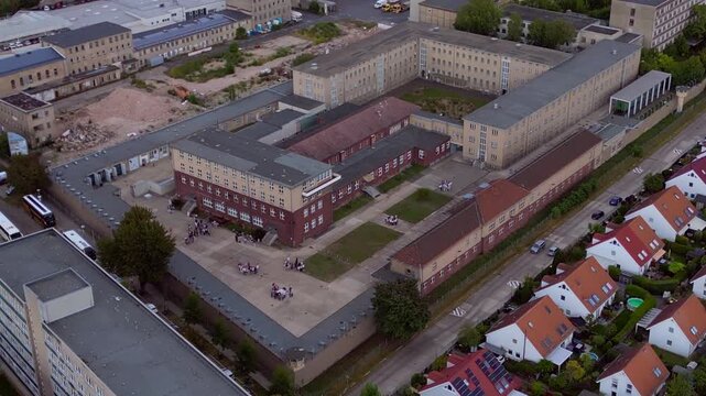 Berlin Hohenschoenhausen Memorial, a former Stasi prison, representing political persecution and communist dictatorship. Smooth aerial view drone panorama flying backward