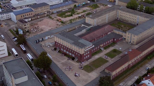 Berlin Hohenschoenhausen Memorial, a former Stasi prison, representing political persecution and communist dictatorship. Perfect aerial view static hovering drone panorama
