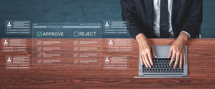 Businessman using laptop for decision making with graphical user interface and approval reject options in a modern office environment. Bitwise.