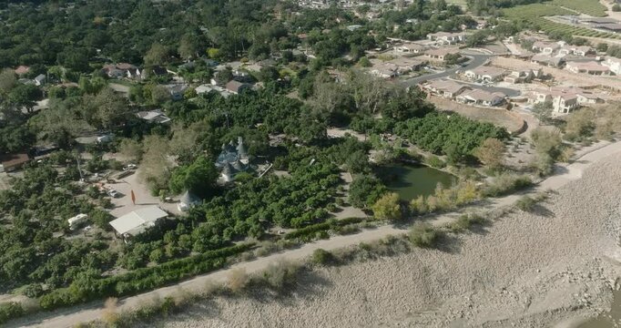 aerial view of forested European countryside with village and road